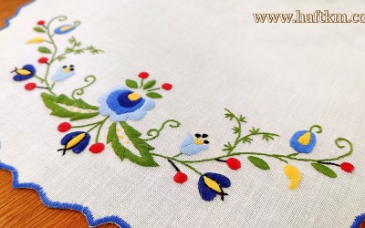 Hand-embroidered linen tablecloth with a Kashubian motif.