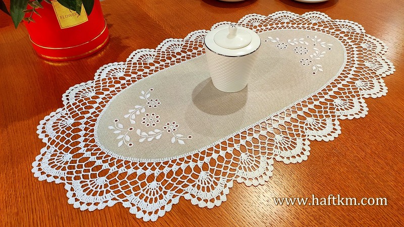 Hand embroidered doily with crochet lace.