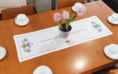 Hand-embroidered table runner with a Kashubian motif.